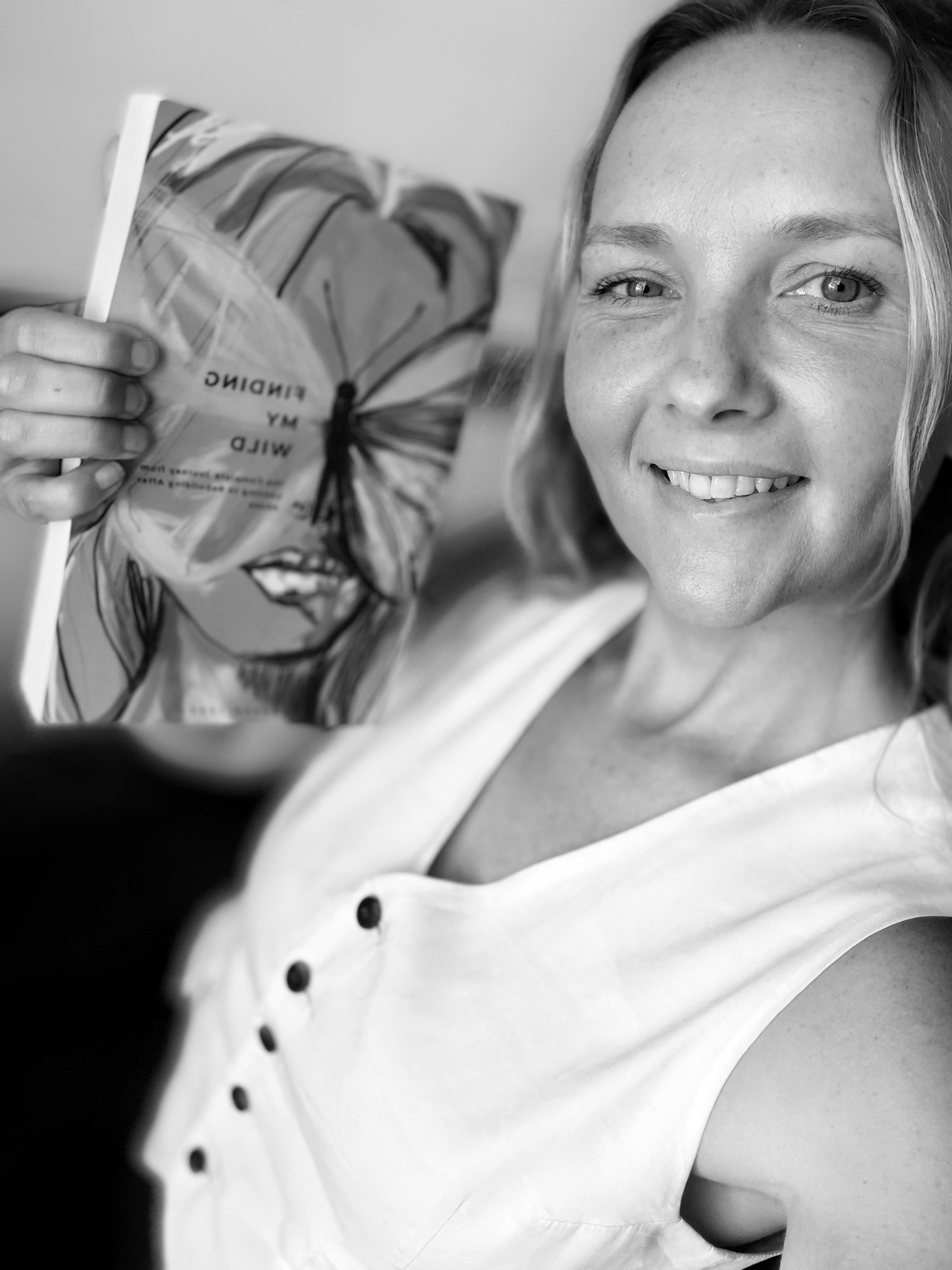 Lauren Jane holding her memoir Finding My Wild