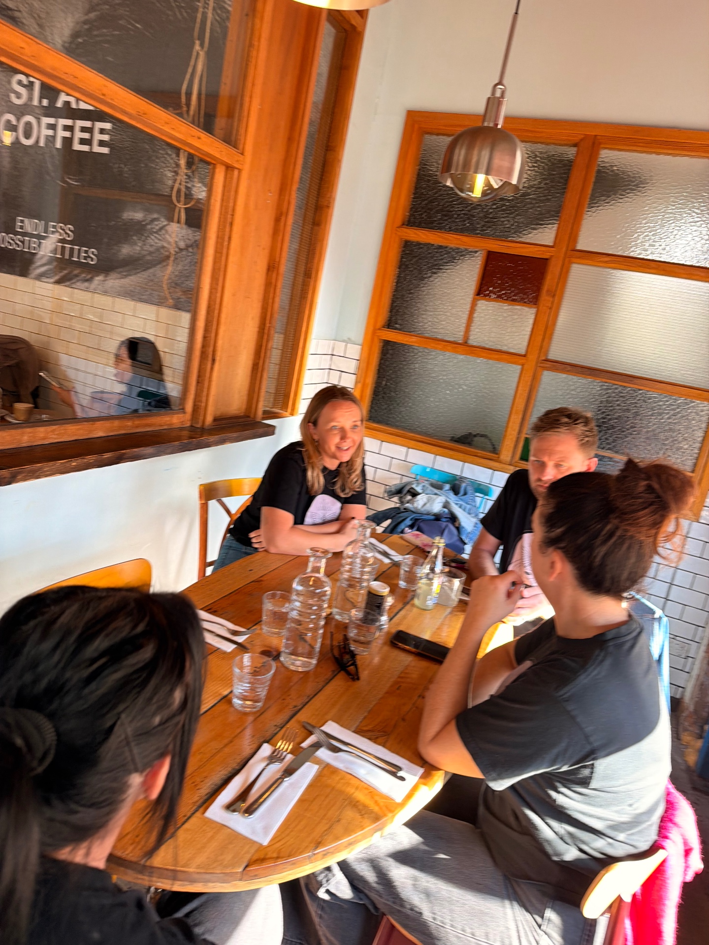 Lauren Jane and the team talking around a cafe table
