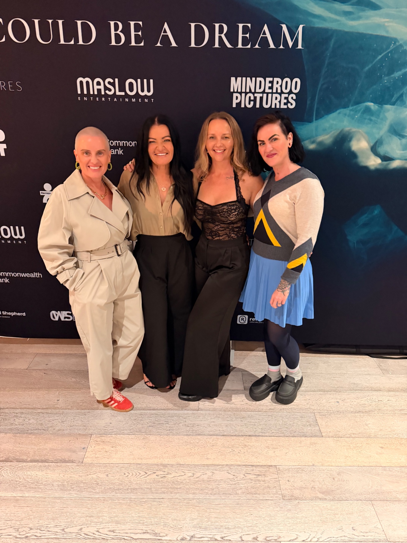 Lauren Jane with three women on the premiere media wall