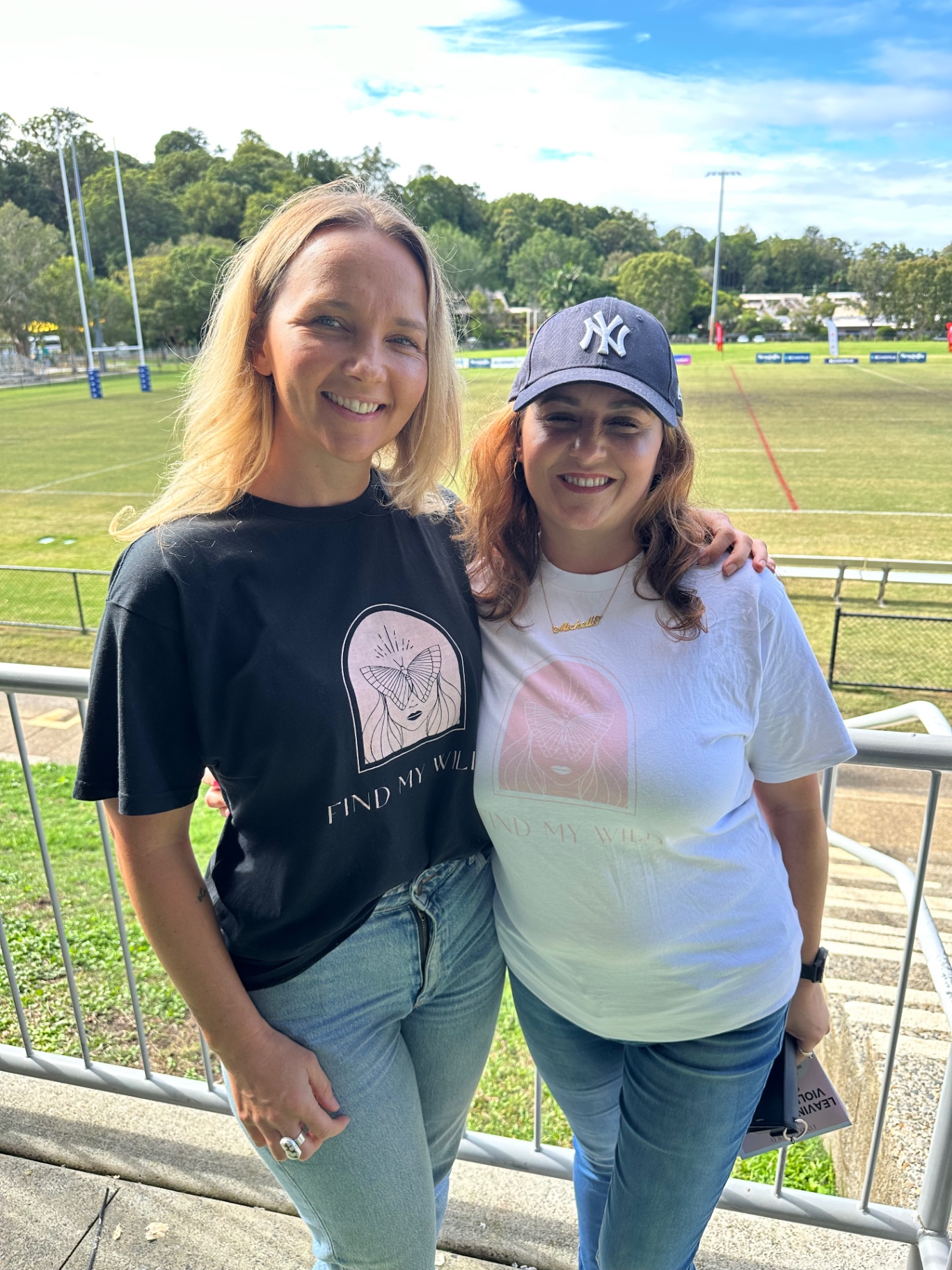 Two supporters wearing Find My Wild tees at a community event