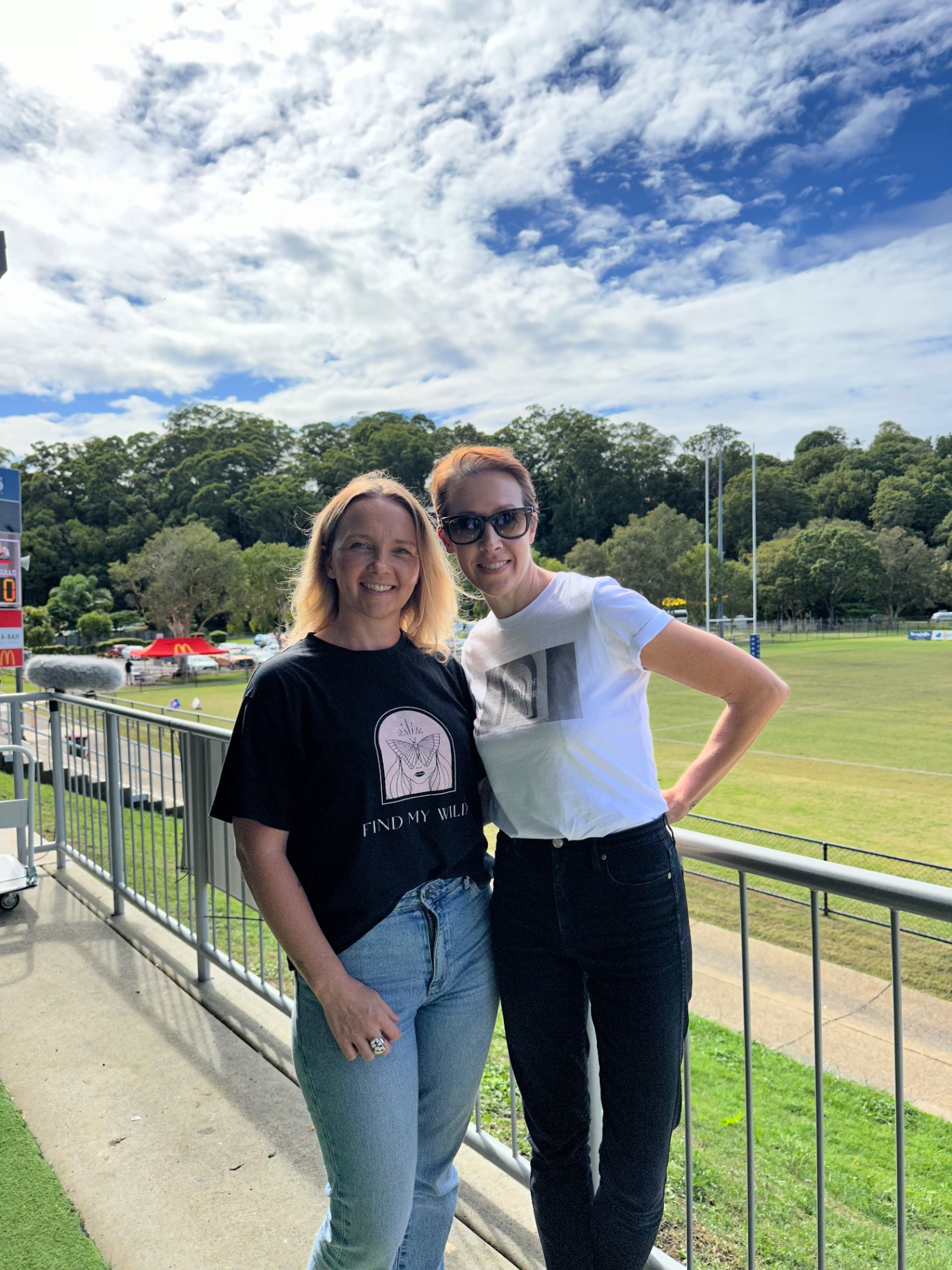 Lauren Jane in a Find My Wild tee with a supporter at the football
